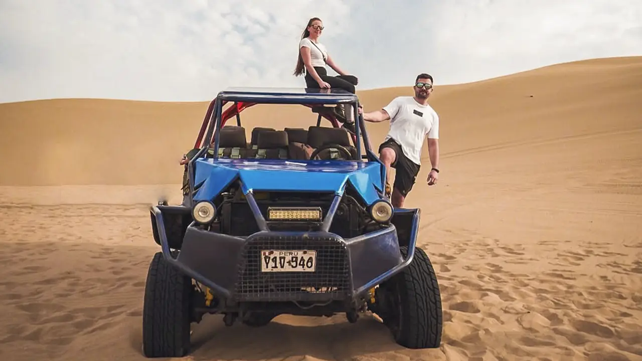 Tourists at dunes of Huacachina